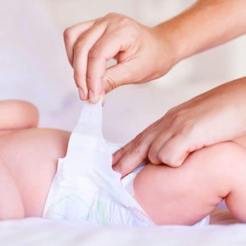 parent changing baby nappy